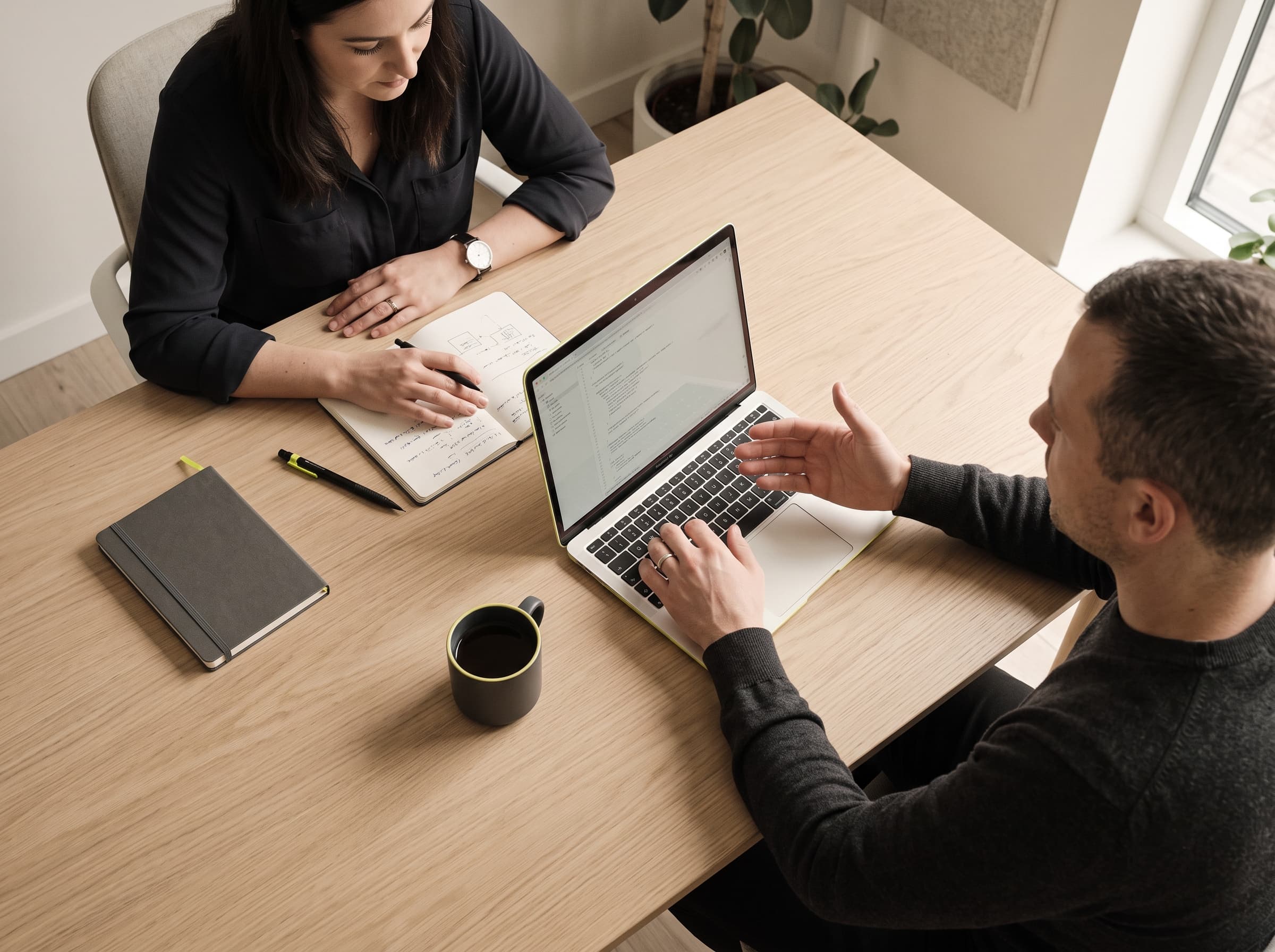Two Blueseal colleagues reviewing an automation on a laptop